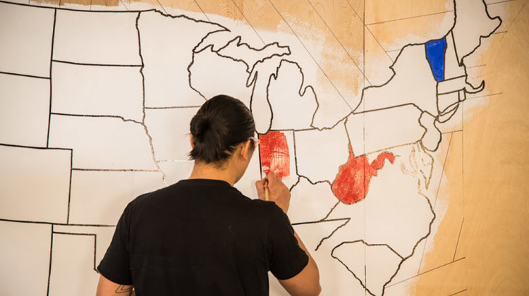 An artist paints a mural indicating which presidential candidate has won certain states on election night in 2016. Once again, NPR will rely on The Associated Press to provide election results and race calls.  - Stephen Voss/NPR