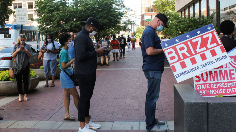 Indianapolis voters – many wearing masks – wait in line to vote at a polling place on Election Day. - Lauren Chapman/IPB News