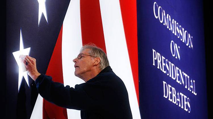 Michael Foley polishes one of the lighted stars on the set for the vice-presidential debate between Republican vice-presidential nominee Gov. Mike Pence and Democratic vice-presidential nominee Sen. Tim Kaine at Longwood University in Farmville, Va., Monday, Oct. 3, 2016. - AP Photo/Steve Helber