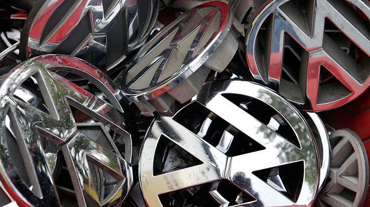 Volkswagen ornaments sit in a box in a scrap yard in Berlin, Germany, Wednesday, Sept. 23, 2015.  - AP Photo/Michael Sohn