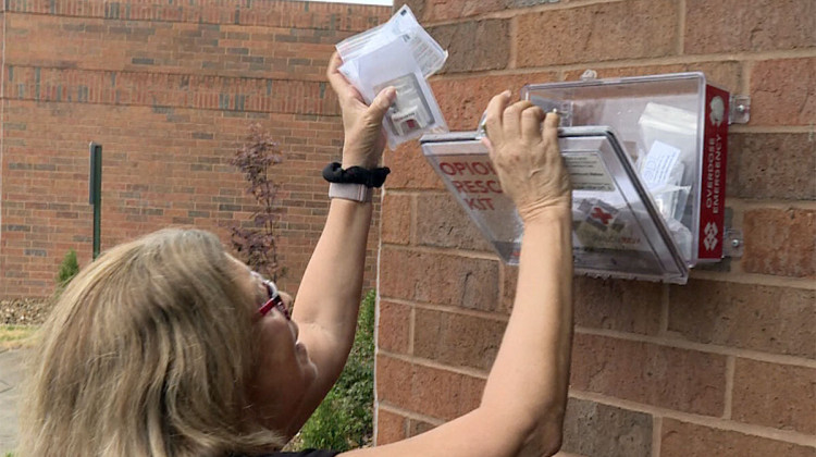 Karen Warpenburg, executive director of the Evansville Recovery Alliance, refills an overdose reversal kit in Evansville, Indiana. - Mitch Legan / WTIU/WFIU News