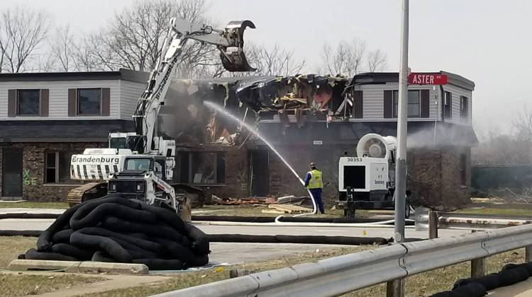 Crews begin tearing down a portion of the West Calumet Housing Complex on April 2. They drench the debris to prevent the spread of lead and arsenic contamination to the surrounding neighborhood.  - (Lauren Chapman/IPB News)