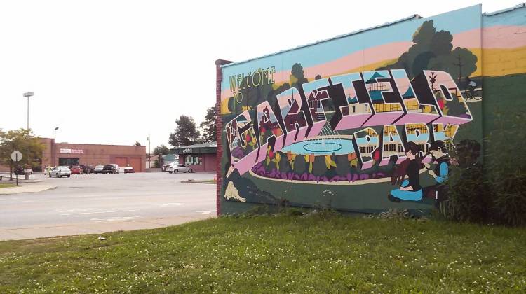 A mural designed by local non-profit Big Car and painted by residents of the Garfield Park neighborhood, on the side of Suding Hardware. Across Shelby street, the former tanning salon where Texas-based non-profit Responsive Education hoped to open a charter school.  - Photo by Andrea Muraskin