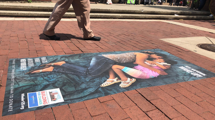 Wheeler Mission has 20 similar images of mothers and children displayed across high-traffic sidewalks in downtown Indianapolis. The guerrilla art is part of the nonprofit's campaign to expand its Women and Children's shelter. - Sarah Panfil/WFYI