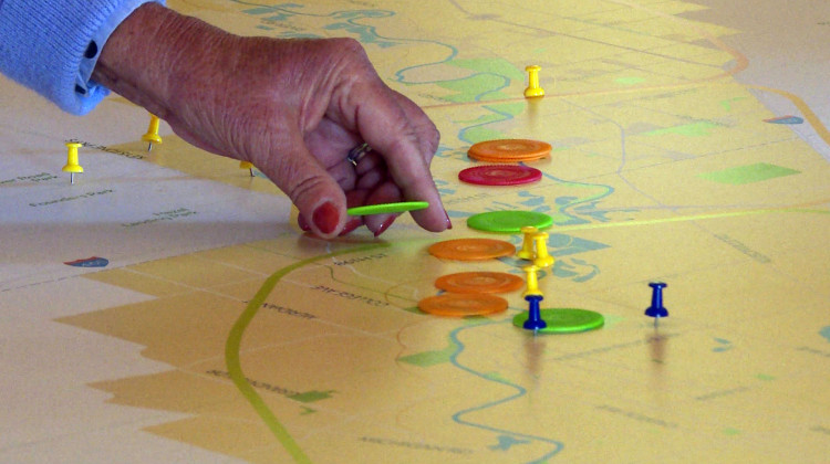 Residents near Carmel placed chips along a map of the river to show what places they think should be preserved (green), enhanced (orange), left alone (blue), or if the designers should develop an new destination (red). - (Rebecca Thiele/IPB News)