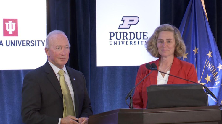 Purdue president Mitch Daniels (left) and Indiana University president Pamela Whitten (right) at Friday's announcement in Indianapolis.  - Devan Ridgway, WFIU/WTIU News