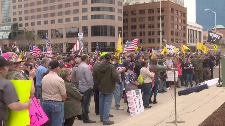 Protesters lined most of the wide sidewalk in front of the Indiana Statehouse. (Lauren Chapman/IPB News) - Protesters lined most of the wide sidewalk in front of the Indiana Statehouse. (Lauren Chapman/IPB News)