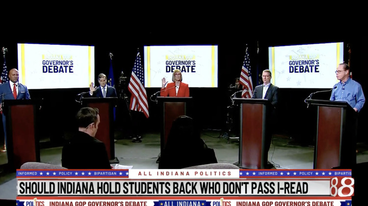Brad Chambers and Suzanne Crouch raised their hands during the WISH-TV Republican gubernatorial primary debate on March 27, 2024 when asked which candidates support the state's new reading retention law. Curtis Hill, at left, and Eric Doden and Mike Braun, at right, did not. - Screenshot of WISH TV live stream