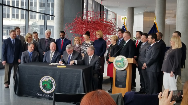 Gov. Eric Holcomb signs workforce bills with Indiana lawmakers and business leaders on March 21. - Samantha Horton/IPB News