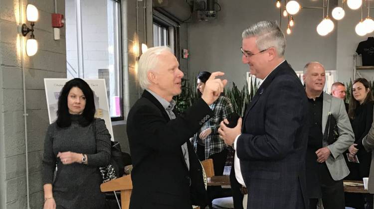 Gov. Eric Holcomb talks with Chris Redlitz, founder of The Last Mile coding program for prison inmates. - Drew Daudelin