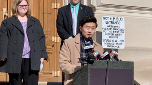 Megan Stoner, left, and Rep. Chris Chyung (D-Dyer), at lectern, support lowering the age limits to serve in the Indiana General Assembly. - Brandon Smith/IPB News