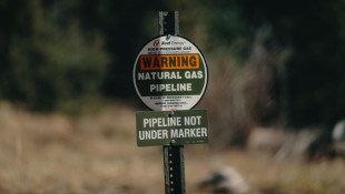 A sign for an Xcel Energy natural gas pipeline buried underground in Colorado, 2018. - Tony Webster/Flickr