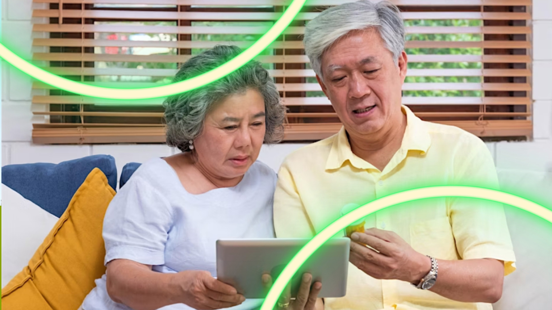 Two aging adults looking at a tablet and a prescription bottle