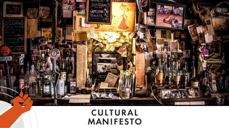 The cluttered yet cozy bar back of the Chatterbox jazz club, featuring photos from over the years, currency from international visitors, newspaper clippings and more. An Oral History of the Chatterbox